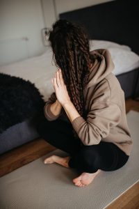 A person holding a smartphone showing a calm meditation app beside a cup of tea